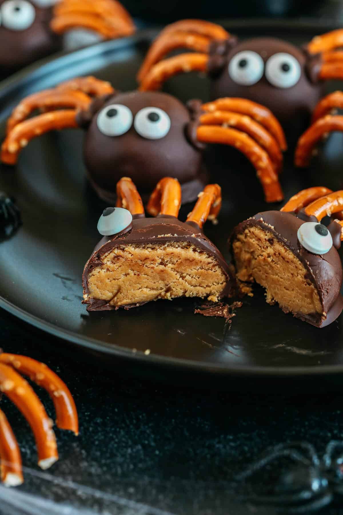 Get festive this Halloween with these tasty Chocolate Peanut Butter Spider Balls made with just 5 simple ingredients and zero baking required!  The perfect sweet and salty treats that are easy to make and your kids will love!