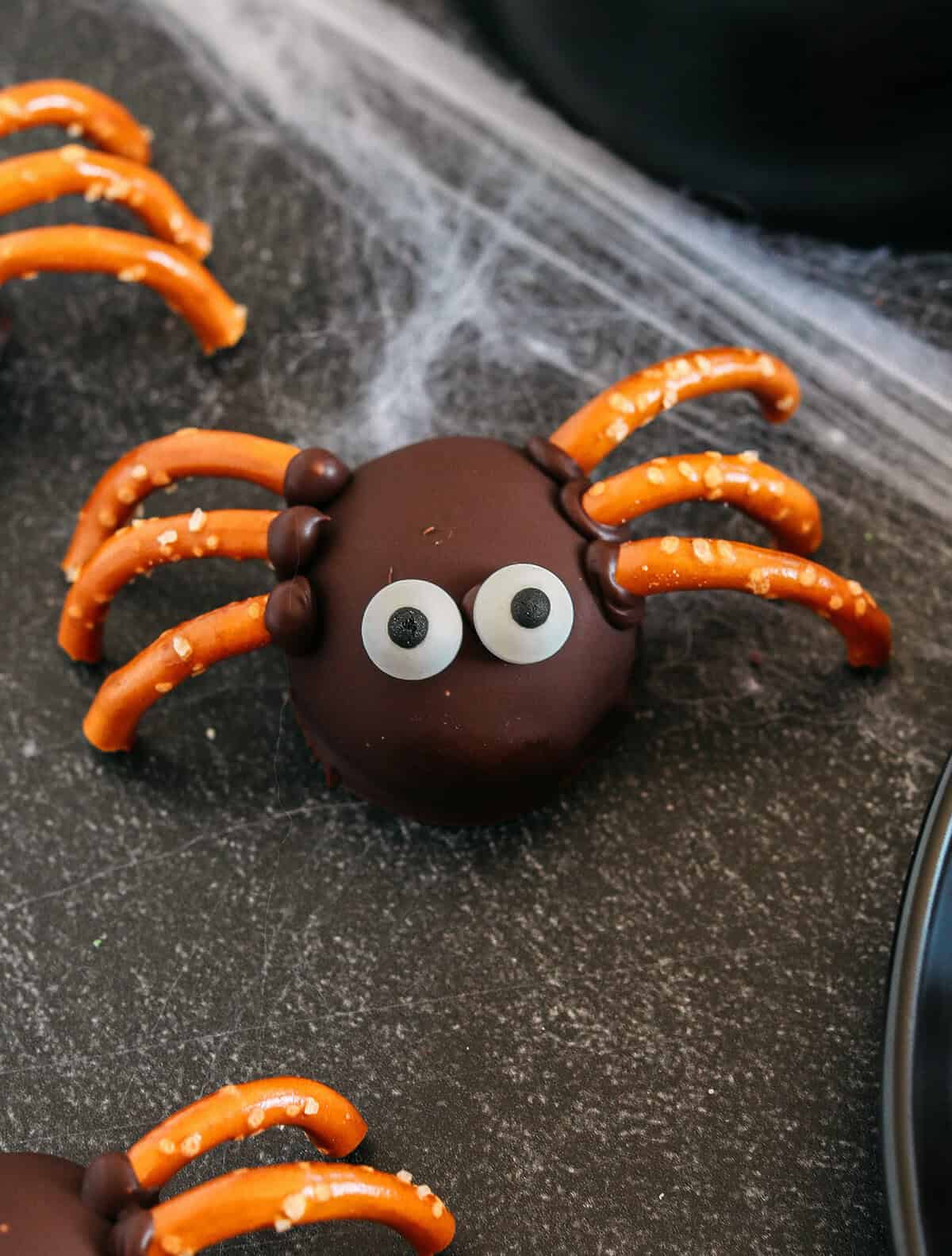 Get festive this Halloween with these tasty Chocolate Peanut Butter Spider Balls made with just 5 simple ingredients and zero baking required!  The perfect sweet and salty treats that are easy to make and your kids will love!
