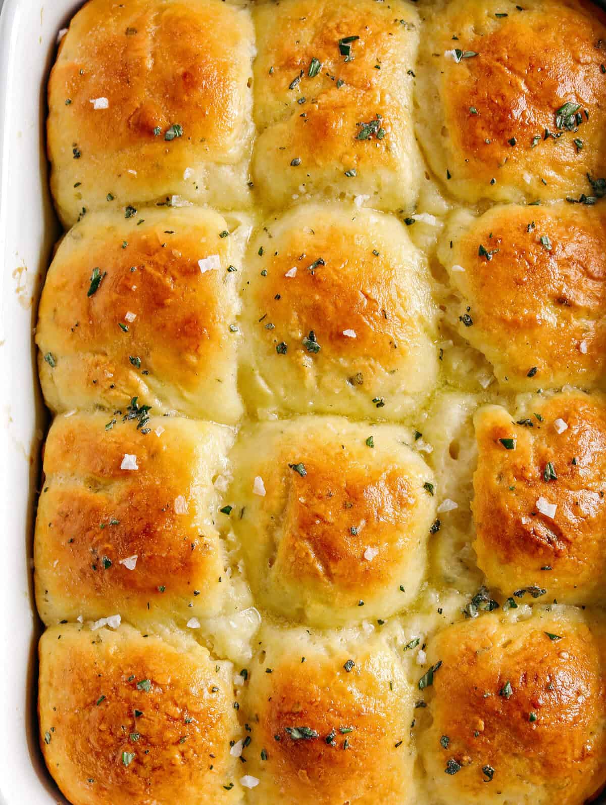 These pull-apart Honey Butter Dinner Rolls are light, fluffy and made without any yeast, eggs or oil.  Infused with honey and fresh herbs, these Parker House-style dinner rolls are perfect for your holiday table this season!