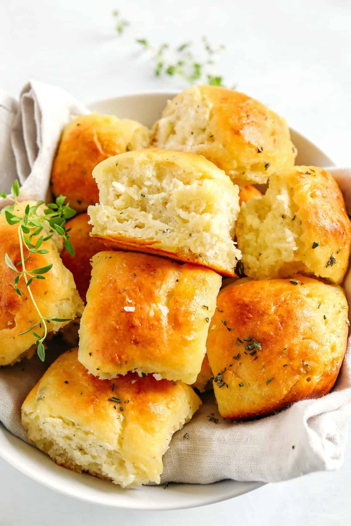 These pull-apart Honey Butter Dinner Rolls are light, fluffy and made without any yeast, eggs or oil.  Infused with honey and fresh herbs, these Parker House-style dinner rolls are perfect for your holiday table this season!