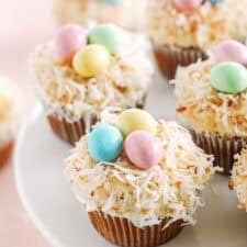 Celebrate Easter with these festive Bird's Nest Carrot Cake Cupcakes that are super moist, naturally sweetened with maple syrup and applesauce, all topped with a cream cheese frosting, toasted coconut and chocolate candies! 