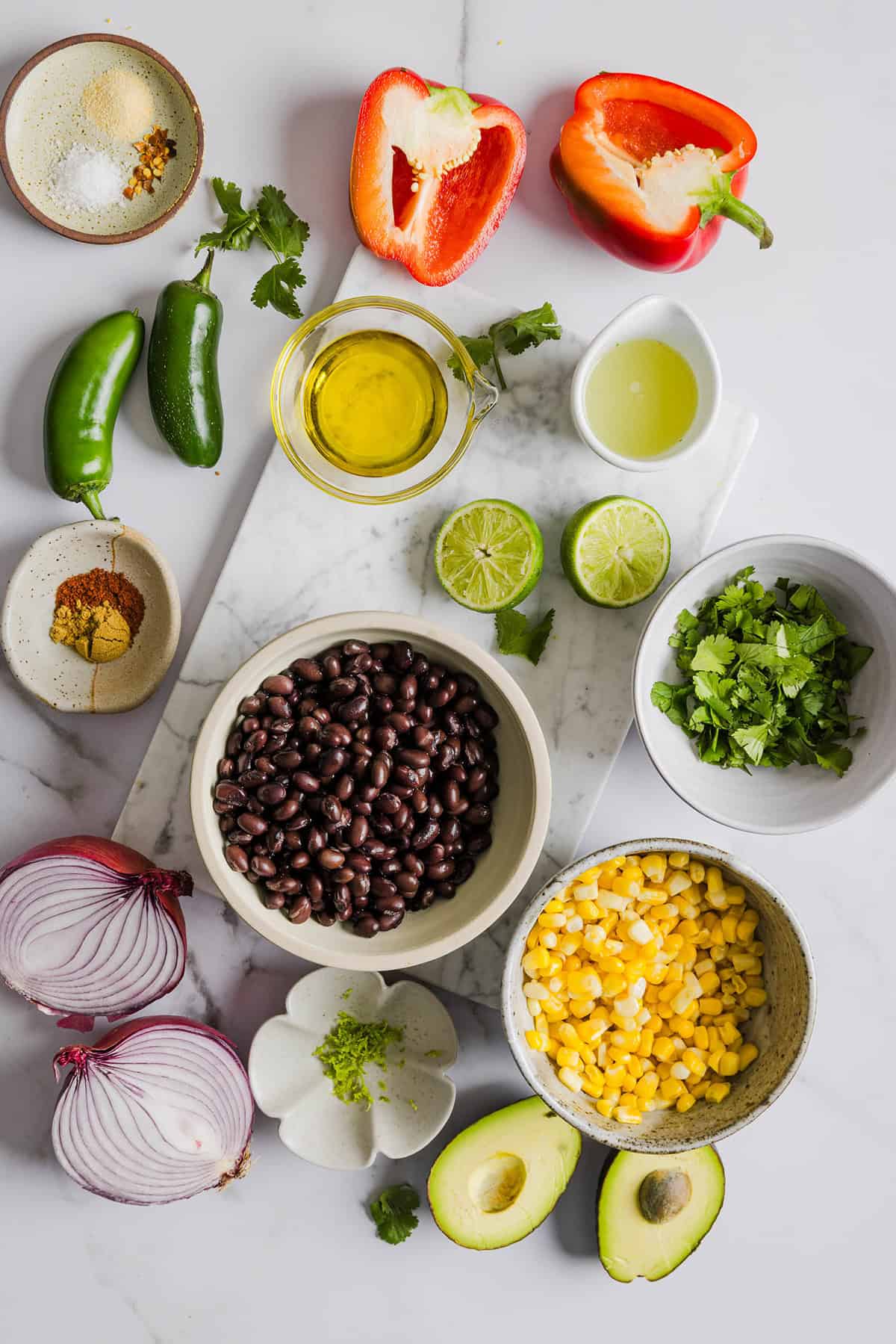 This Black Bean and Corn Salad is loaded with crisp veggies, delicious spices and fresh cilantro, all tossed together in a zesty lime dressing making it the perfect summer side dish or dip!