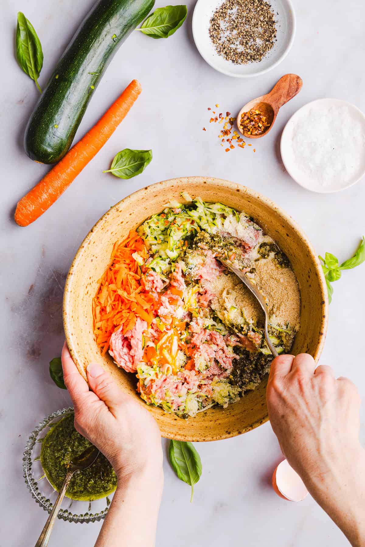 Mouthwatering Baked Chicken Pesto Meatballs made with tender ground chicken, garlicky basil pesto, fresh veggies and parmesan cheese. Juicy, flavorful and make the perfect weeknight meal served over pasta or with rice!