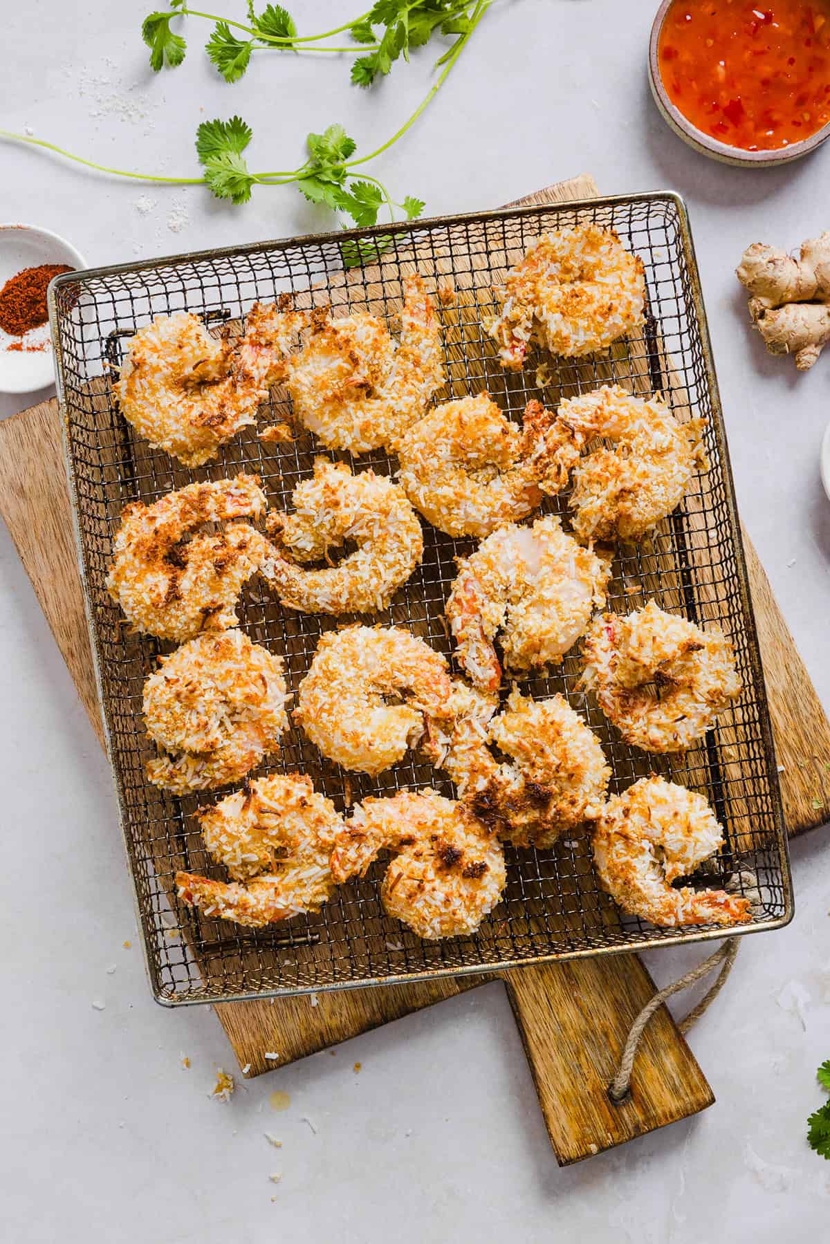 Sweet and Crispy Air Fryer Coconut Shrimp easily made in under 20 minutes and served with the most delicious chili dipping sauce! This appetizer is always a crowd-pleaser,  but also makes a filling main dish served with a salad, veggies or in a wrap.