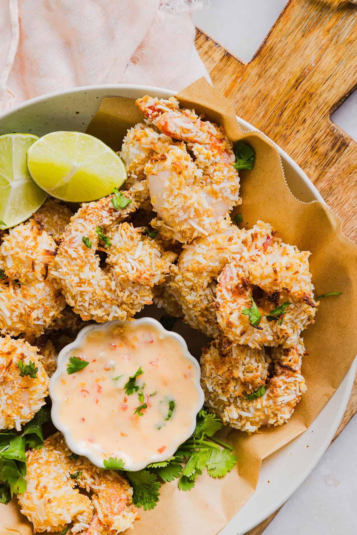 Sweet and Crispy Air Fryer Coconut Shrimp easily made in under 20 minutes and served with the most delicious chili dipping sauce! This appetizer is always a crowd-pleaser,  but also makes a filling main dish served with a salad, veggies or in a wrap.