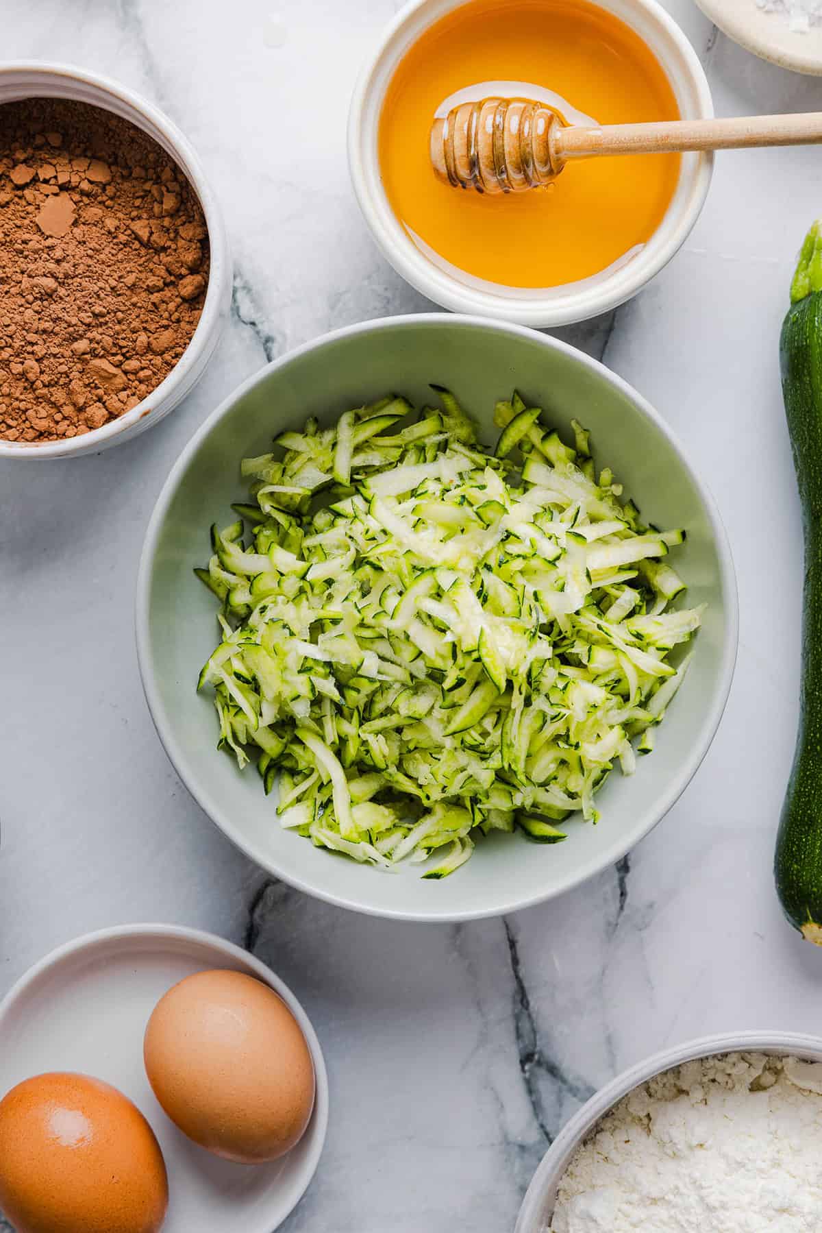 These Fudgy Zucchini Brownies are deliciously moist with a rich chocolate taste loaded with shredded zucchini and made healthier with zero butter or refined sugar!  One of our family's favorite summer desserts!