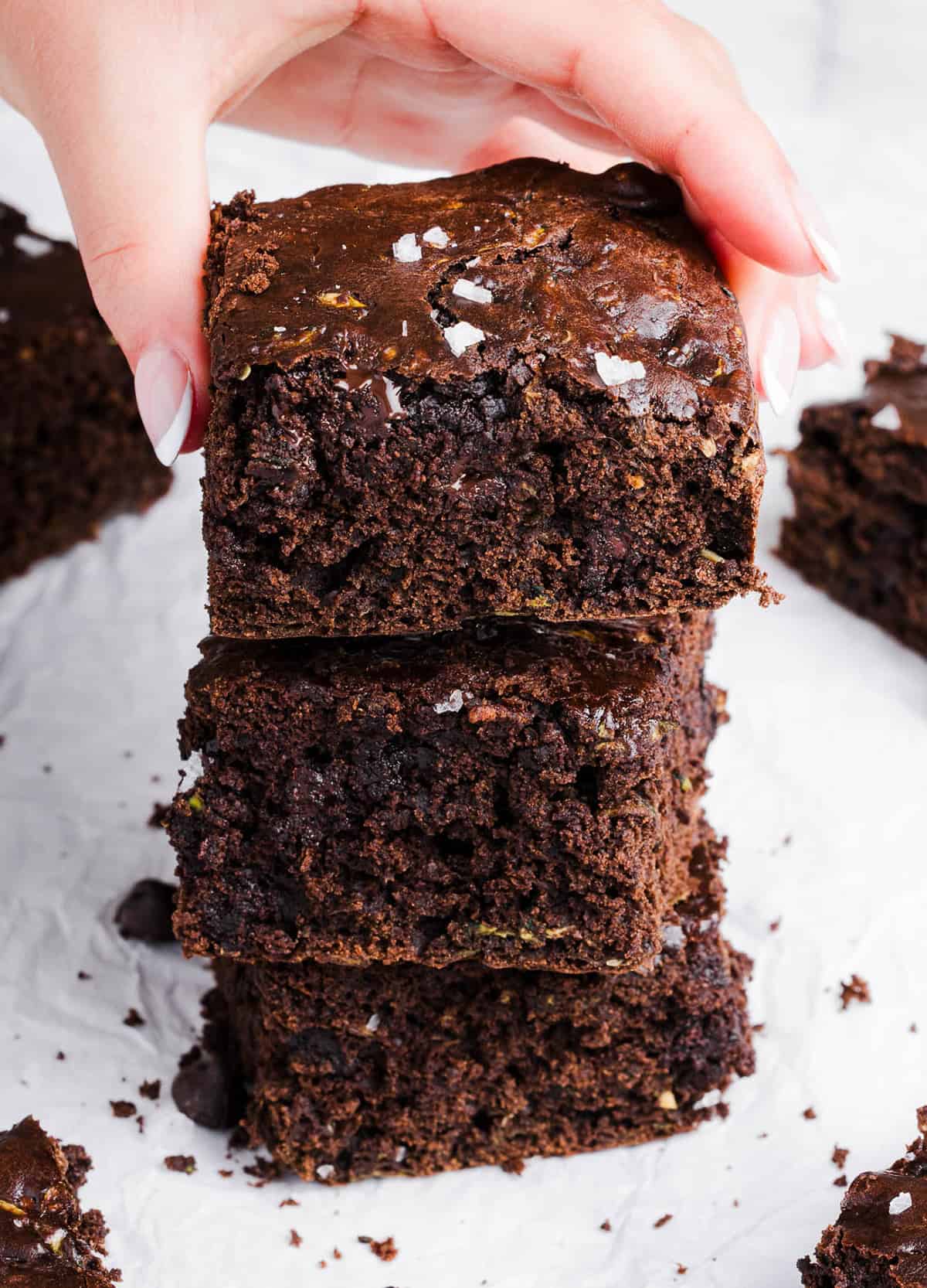 These Fudgy Zucchini Brownies are deliciously moist with a rich chocolate taste loaded with shredded zucchini and made healthier with zero butter or refined sugar!  One of our family's favorite summer desserts!