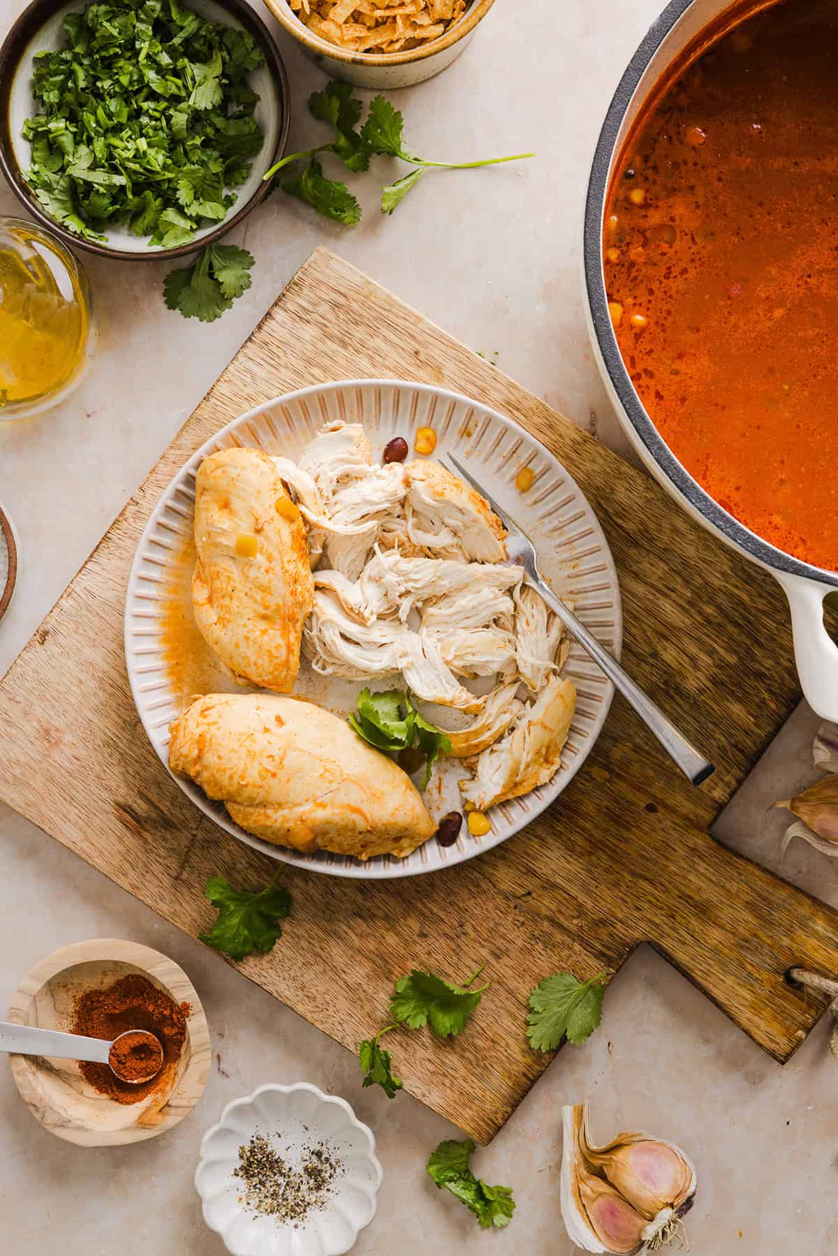 This Easy Chicken Tortilla Soup makes the perfect weeknight meal that can easily be made right in your instant pot, slow cooker or on the stove! Packed with tender shredded chicken, veggies, beans and all the toppings for a delicious, flavor-packed meal!