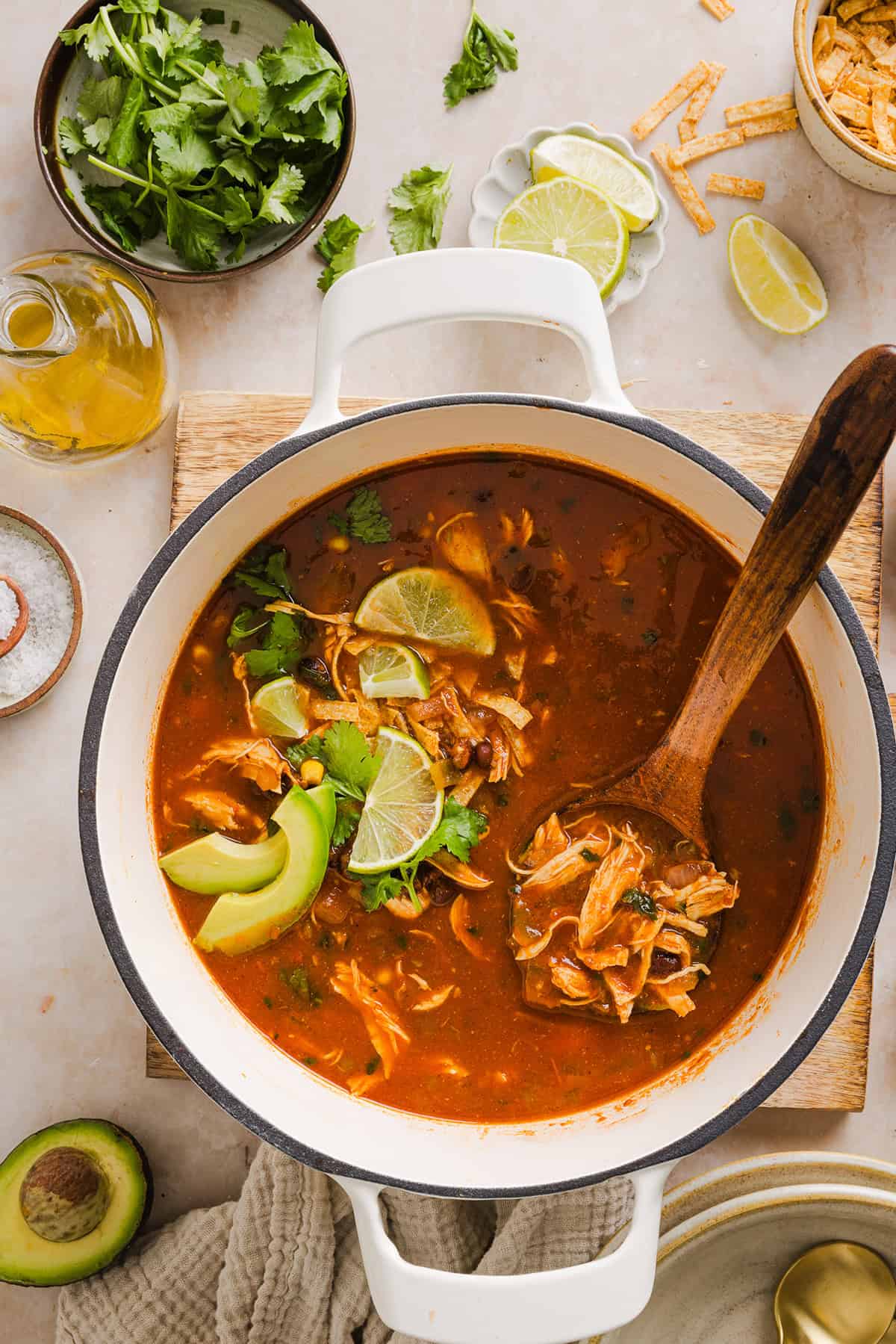 This Easy Chicken Tortilla Soup makes the perfect weeknight meal that can easily be made right in your instant pot, slow cooker or on the stove! Packed with tender shredded chicken, veggies, beans and all the toppings for a delicious, flavor-packed meal!