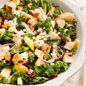 This fresh and flavorful Harvest Chopped Chicken Salad is made with leafy kale, tender juicy chicken, chopped apples and crunchy pecans all tossed with a maple dijon dressing! This salad is hearty enough for dinner and light enough for lunch!