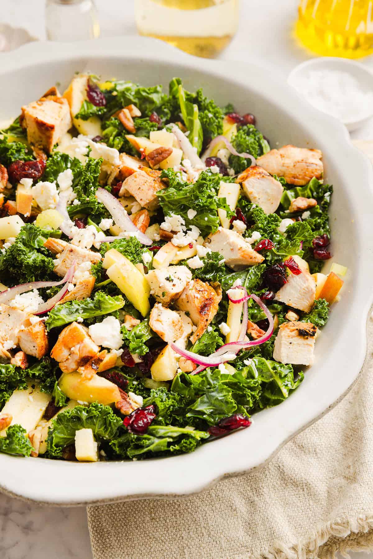 This fresh and flavorful Harvest Chopped Chicken Salad is made with leafy kale, tender juicy chicken, chopped apples and crunchy pecans all tossed with a maple dijon dressing! This salad is hearty enough for dinner and light enough for lunch!
