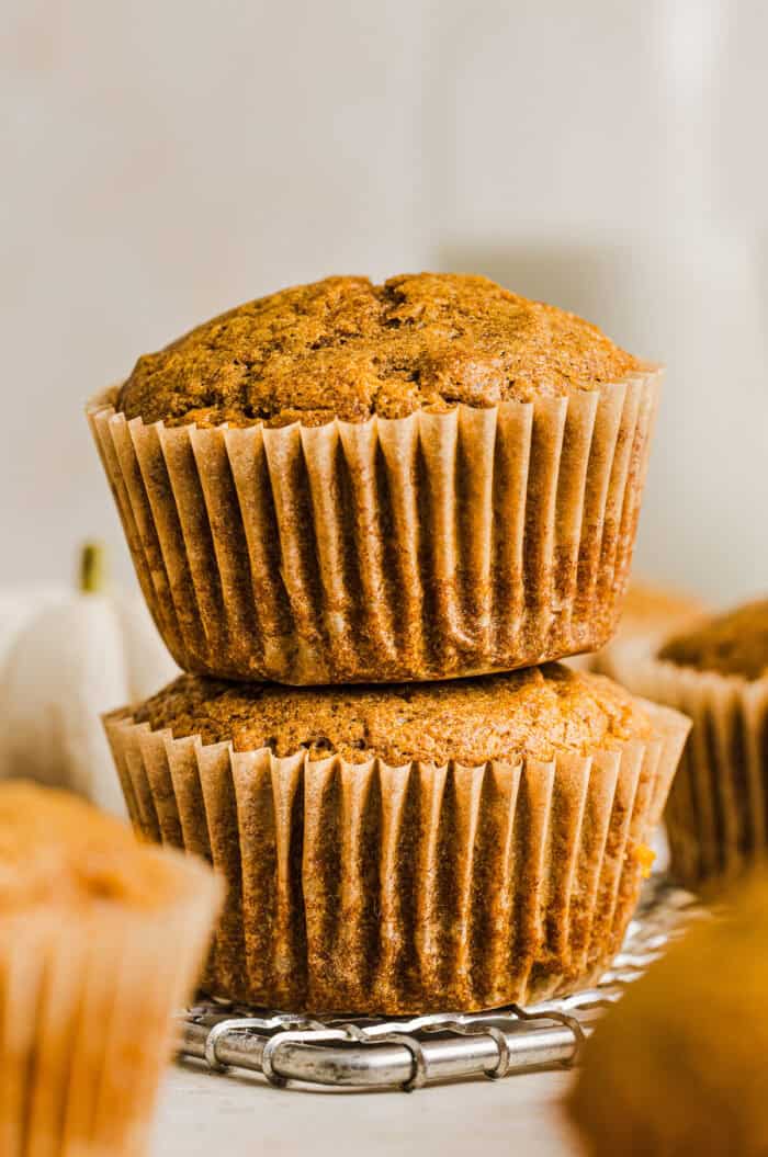 These Whole Wheat Pumpkin Muffins are moist, fluffy, and made healthier with whole wheat flour, applesauce, and zero butter or refined sugar.  Loaded with delicious pumpkin flavor and warm spices for the perfect fall muffin!