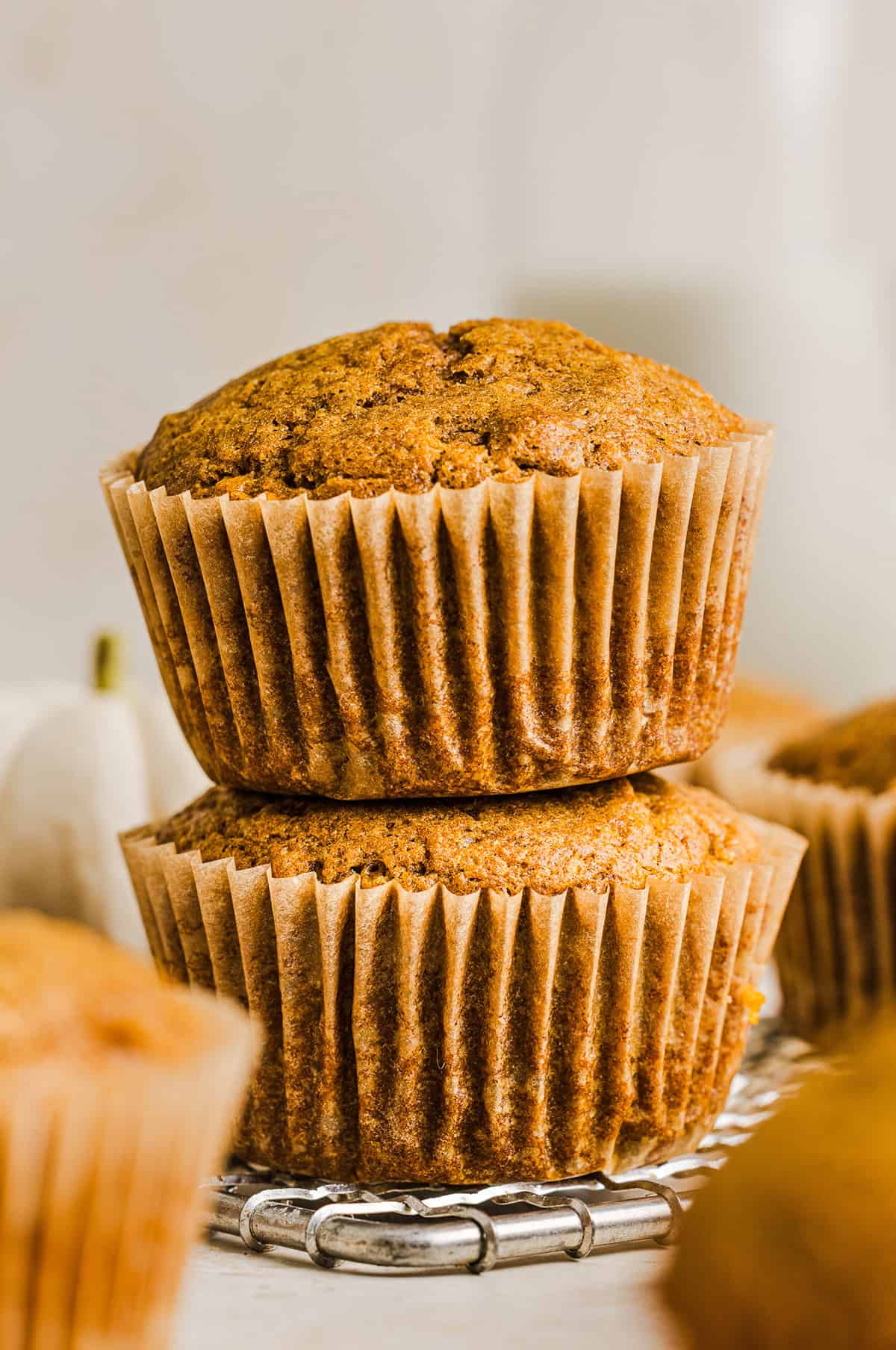 These Whole Wheat Pumpkin Muffins are moist, fluffy, and made healthier with whole wheat flour, applesauce, and zero butter or refined sugar.  Loaded with delicious pumpkin flavor and warm spices for the perfect fall muffin!