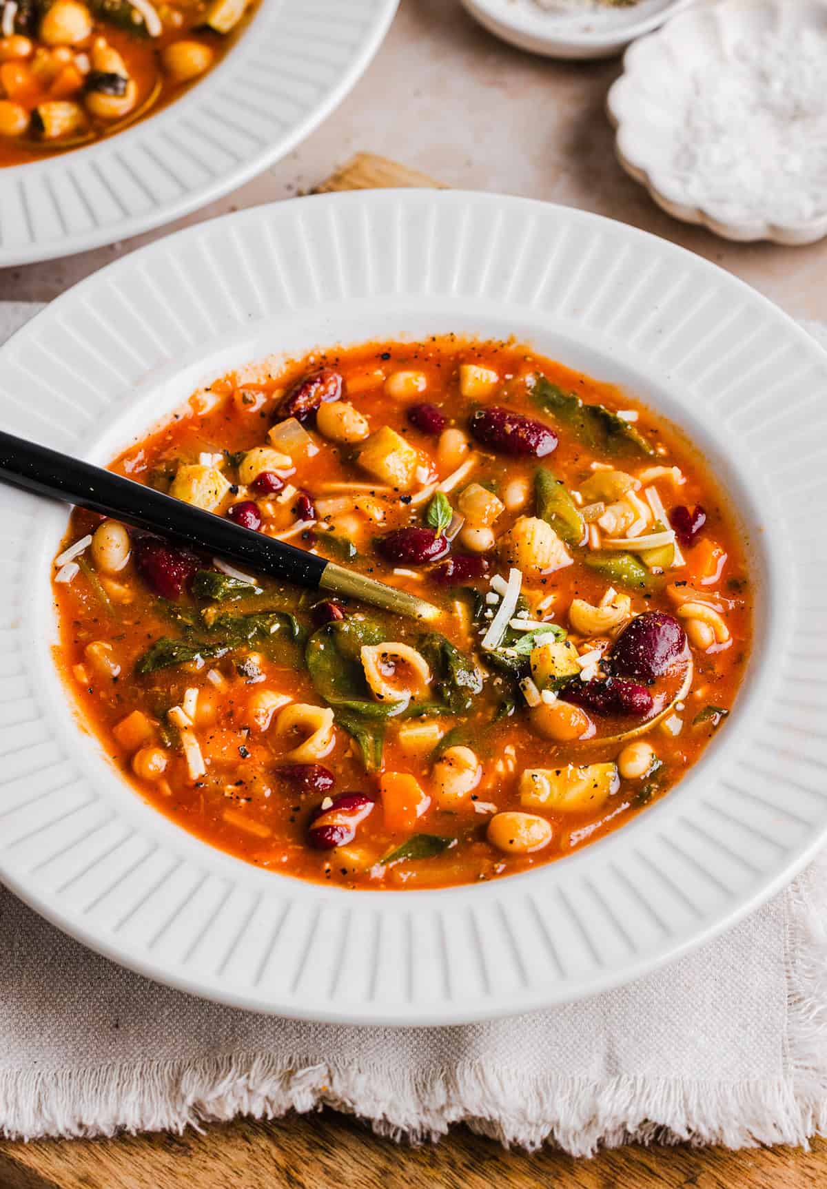 Easy and delicious Olive Garden Minestrone Soup loaded with fresh veggies, leafy greens and simmered in the most flavorful broth! Easily made in one pot for a cozy weeknight dinner the whole family will love!