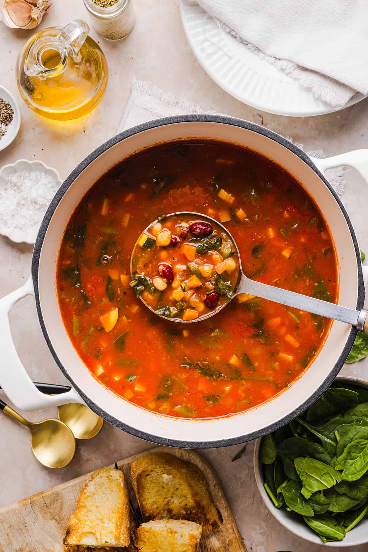 Easy and delicious Olive Garden Minestrone Soup loaded with fresh veggies, leafy greens and simmered in the most flavorful broth! Easily made in one pot for a cozy weeknight dinner the whole family will love!