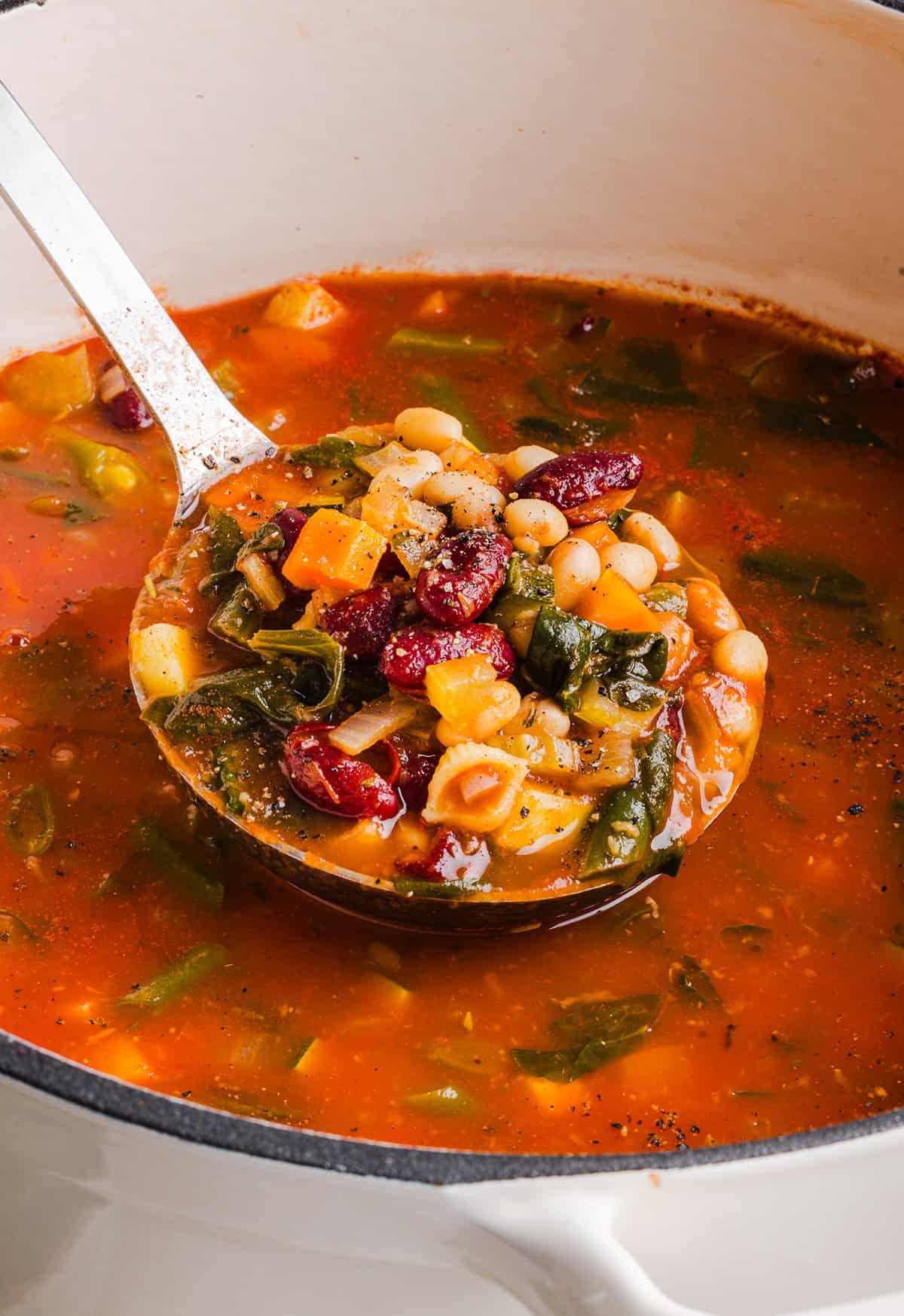 Easy and delicious Olive Garden Minestrone Soup loaded with fresh veggies, leafy greens and simmered in the most flavorful broth! Easily made in one pot for a cozy weeknight dinner the whole family will love!