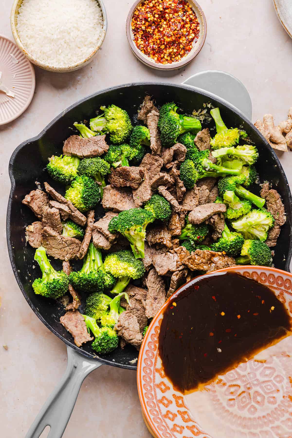 You'll love this Healthy Beef and Broccoli recipe made with tender flank steak, crisp broccoli and a savory garlic ginger sauce.  A quick and easy weeknight dinner that tastes better than take-out and comes together in under 30 minutes!