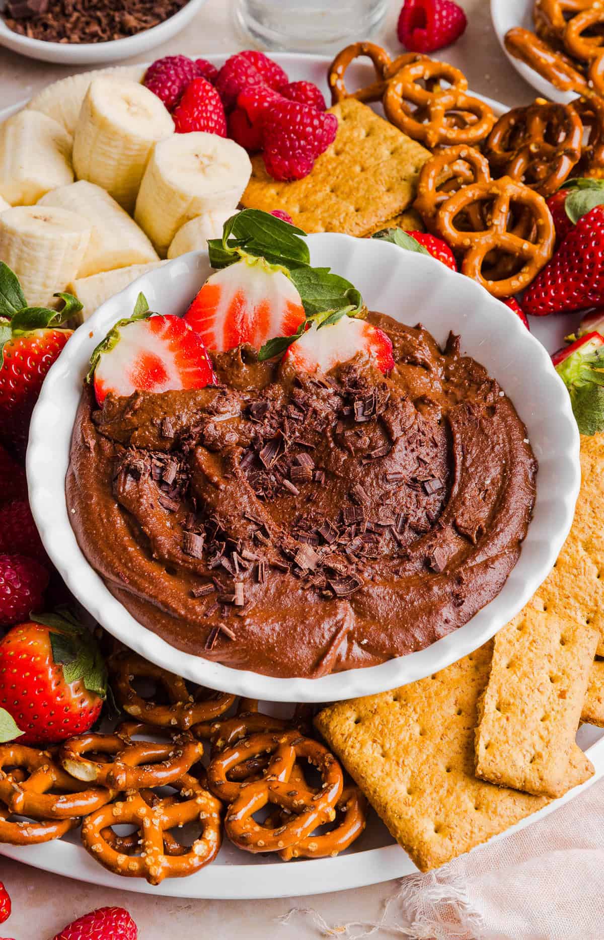 This Healthy Chocolate Hummus is rich and indulgent to satisfy your sweet tooth, but made with wholesome ingredients that you can feel good about eating! Serve with your favorite fruit, pretzels or graham crackers for the perfect fun dessert or snack!