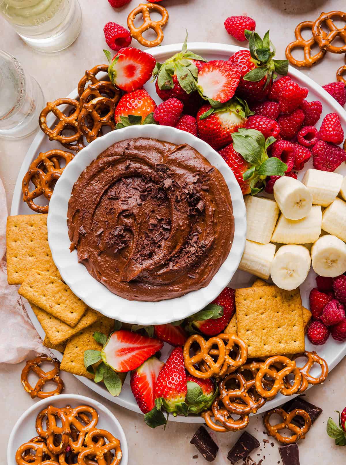 This Healthy Chocolate Hummus is rich and indulgent to satisfy your sweet tooth, but made with wholesome ingredients that you can feel good about eating! Serve with your favorite fruit, pretzels or graham crackers for the perfect fun dessert or snack!