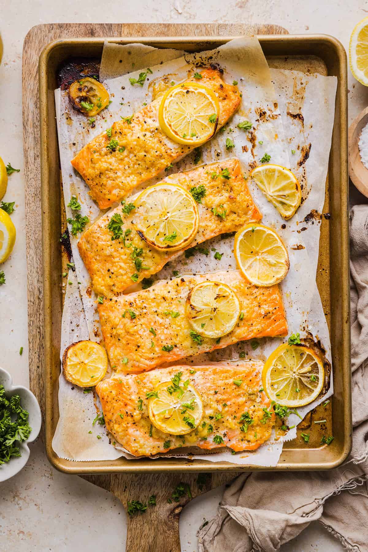 The most flavorful Garlic Butter Baked Salmon that is tender, flaky and coated in a rich garlicky sauce with lemon and Dijon. This simple healthy recipe easily comes together in under 20 minutes!