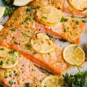 The most flavorful Garlic Butter Baked Salmon that is tender, flaky and coated in a rich garlicky sauce with lemon and Dijon. This simple healthy recipe easily comes together in under 20 minutes!