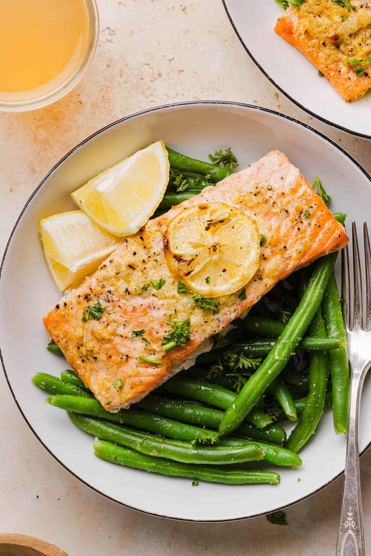 The most flavorful Garlic Butter Baked Salmon that is tender, flaky and coated in a rich garlicky sauce with lemon and Dijon. This simple healthy recipe easily comes together in under 20 minutes!
