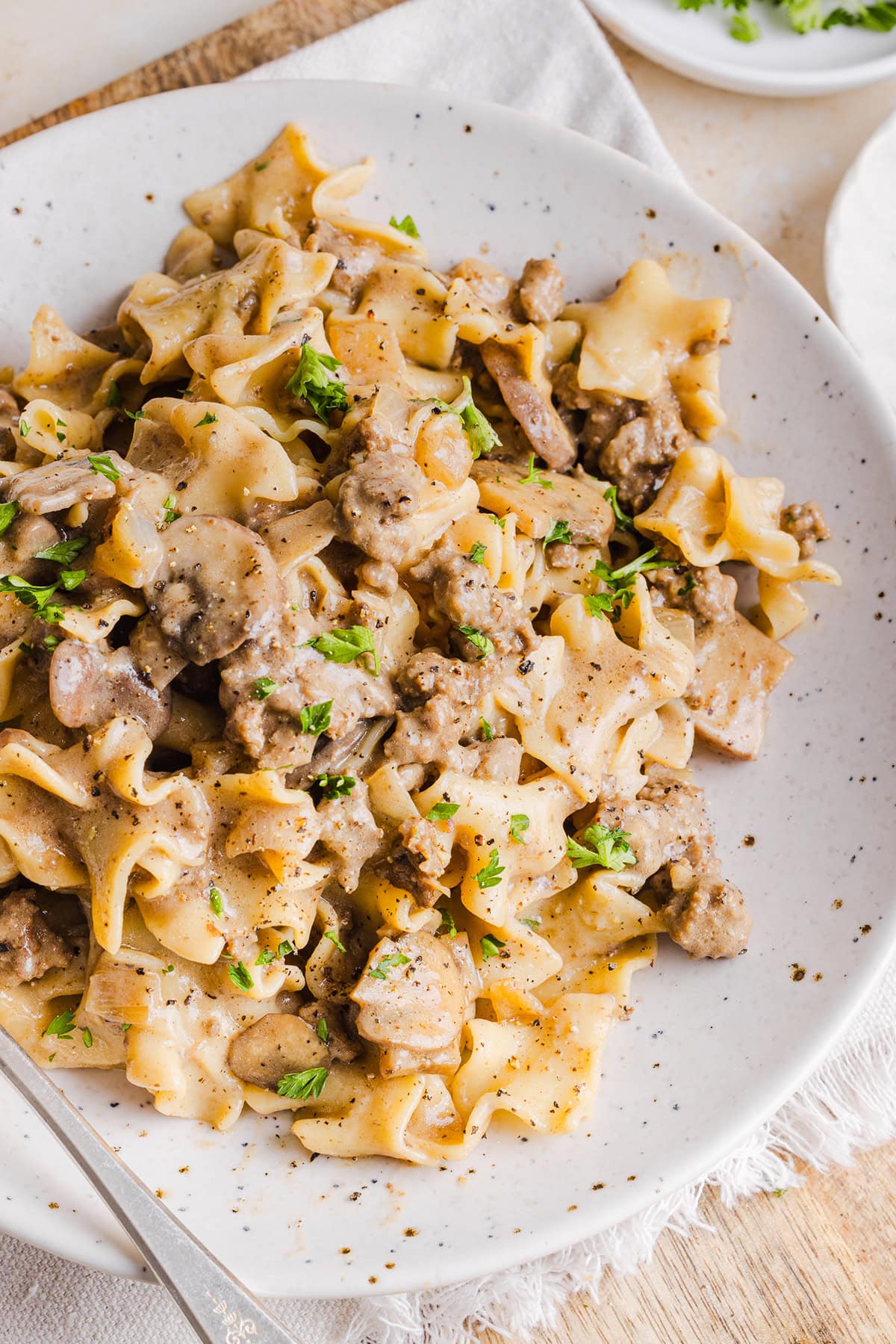 This Healthy Ground Beef Stroganoff Casserole is the ultimate family-friendly comfort food! The perfect cozy weeknight meal made with egg noodles and smothered in the most delicious creamy mushroom sauce in just 30 minutes!