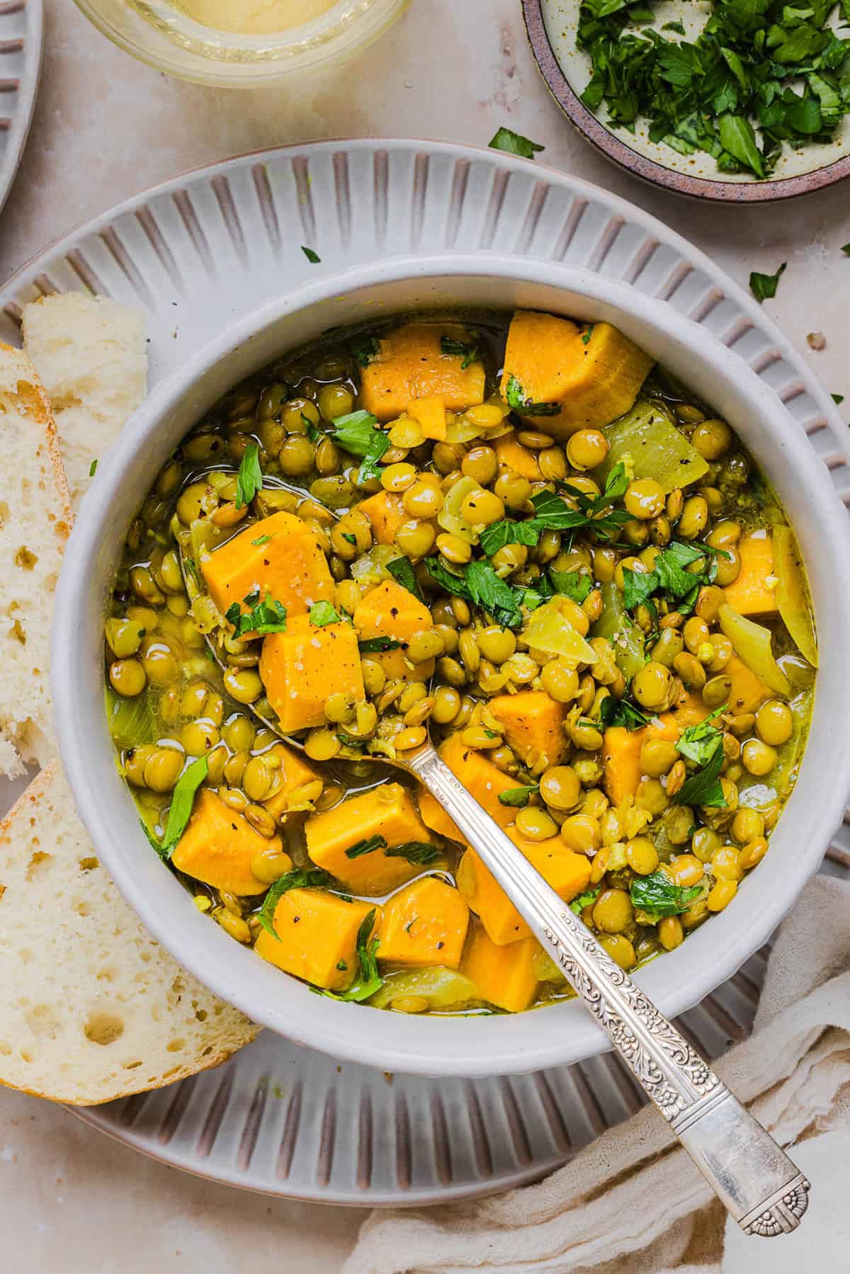 This hearty Lentil and Sweet Potato Stew is is delicious, super filling and easily comes together in under 30 minutes for the perfect weeknight dinner! A nourishing meal made with pantry staples that is gluten-free, dairy-free and vegan.