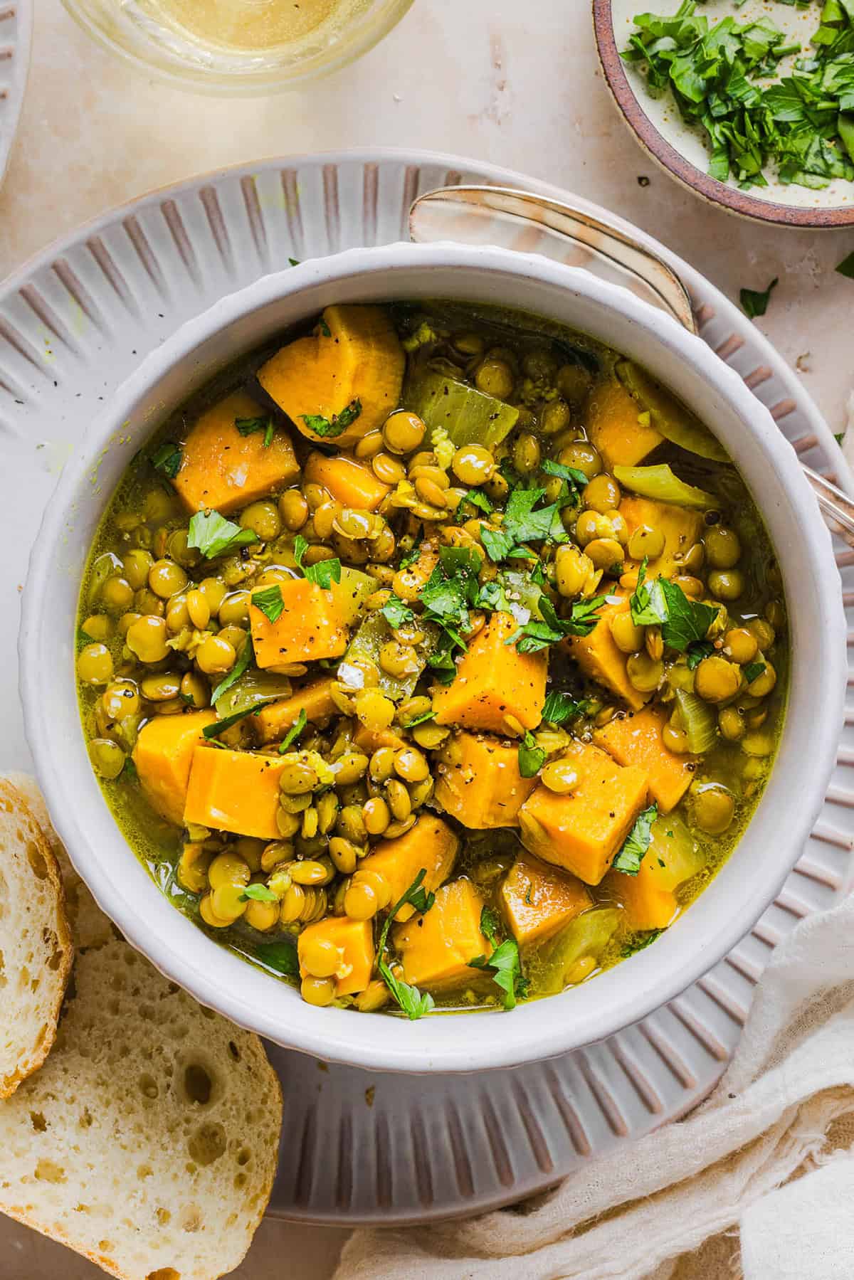 This hearty Lentil and Sweet Potato Stew is is delicious, super filling and easily comes together in under 30 minutes for the perfect weeknight dinner! A nourishing meal made with pantry staples that is gluten-free, dairy-free and vegan.