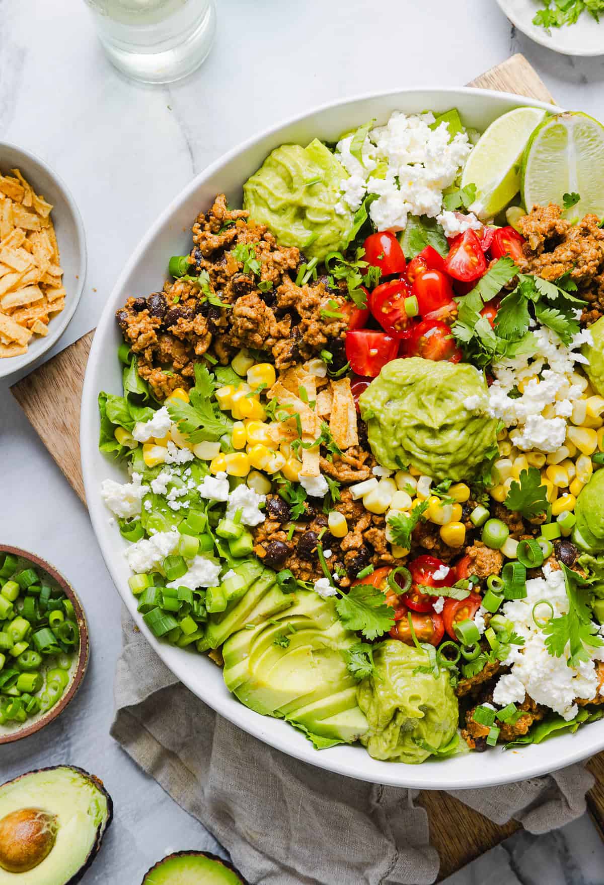 This quick and easy Healthy Taco Salad is packed with seasoned ground turkey, fresh veggies and all your favorite toppings to pack in the flavor! Perfect for busy weeknights, meal prep or even serving a crowd!