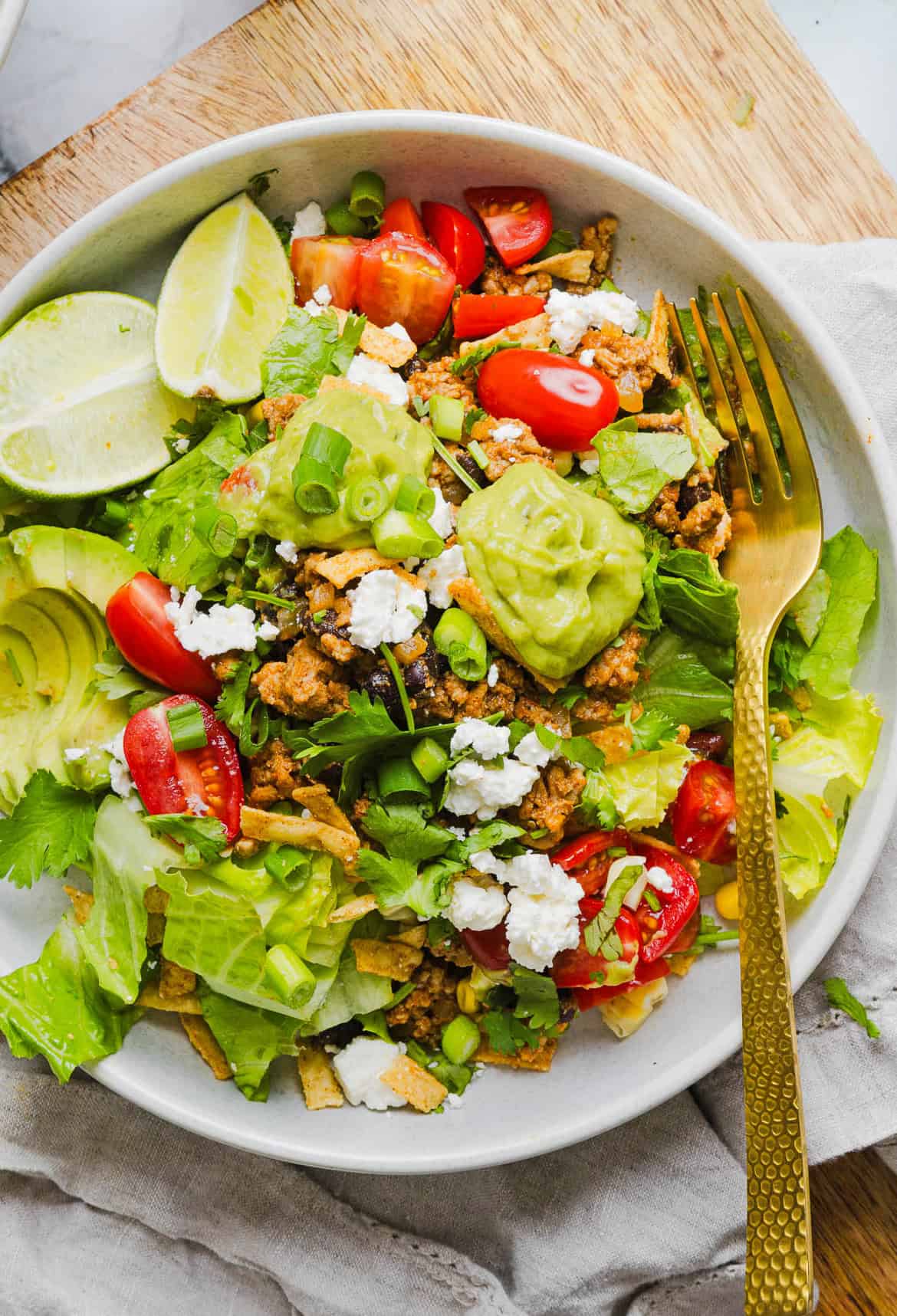 This quick and easy Healthy Taco Salad is made with seasoned ground turkey, fresh veggies and all your favorite toppings to pack in the flavor! Perfect for busy weeknights, meal prep or even serving a crowd!
