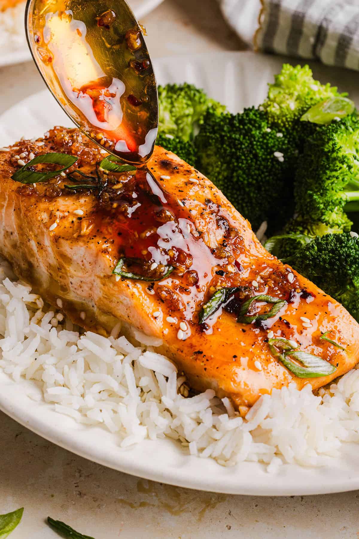 The most flavorful Hot Honey Glazed Salmon that is tender, flaky and coated in a sweet and savory homemade hot honey sauce. This simple healthy recipe easily comes together in under 20 minutes!