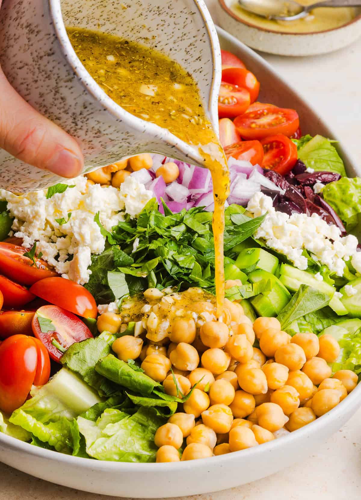 Fresh and crisp Mediterranean Chopped Salad made with fresh tomatoes, crisp cucumbers, red onion, chickpeas, olives and feta cheese all tossed with a delicious red wine vinaigrette! Perfect for meal prep, lunches, or an easy side dish for any meal. 