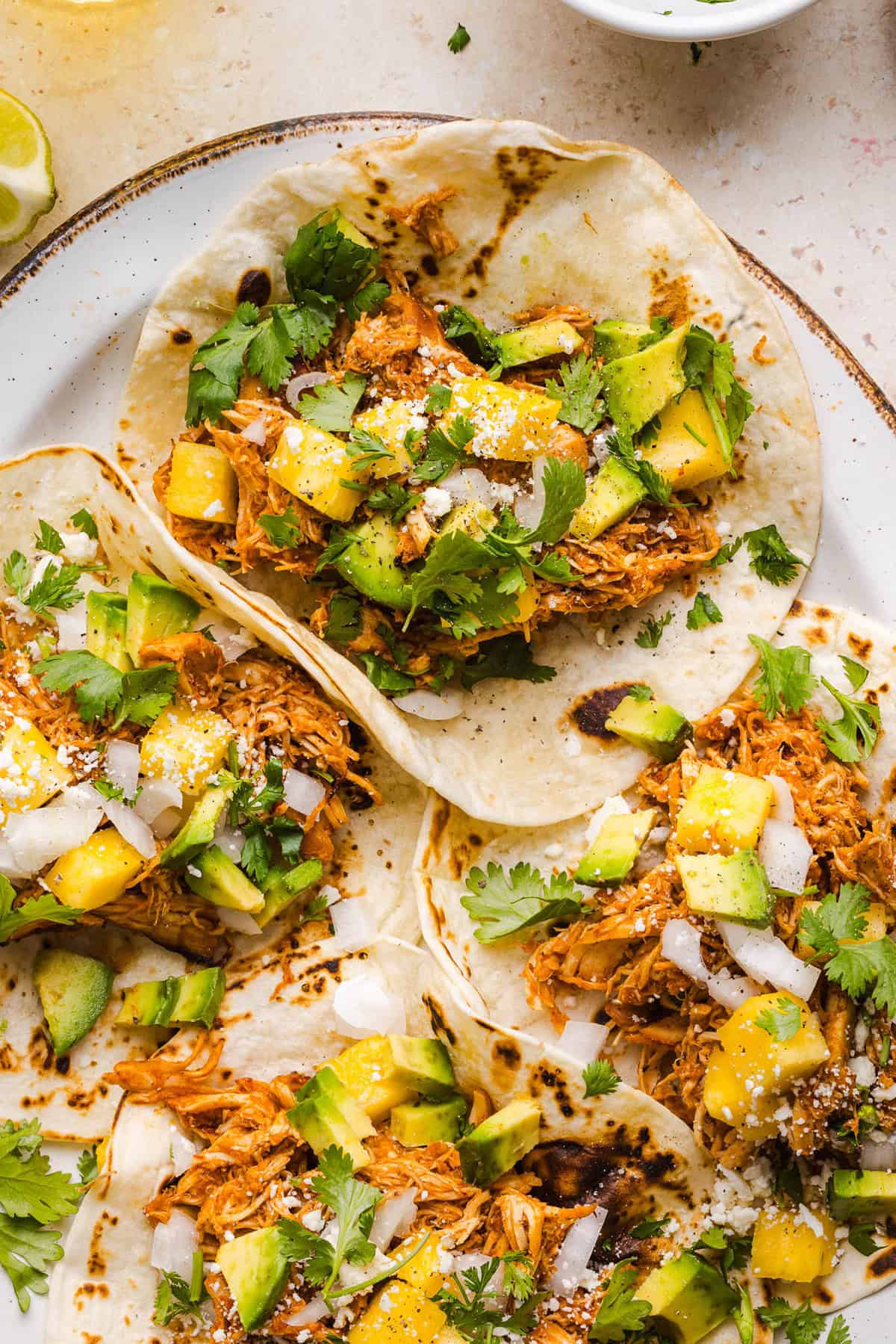These Crock Pot Chicken Al Pastor Tacos are sweet, smoky, and incredibly flavorful! An easy slow cooker dinner made with juicy shredded chicken, fresh pineapple, chipotle peppers, and warm spices for a healthy, protein-packed dinner.