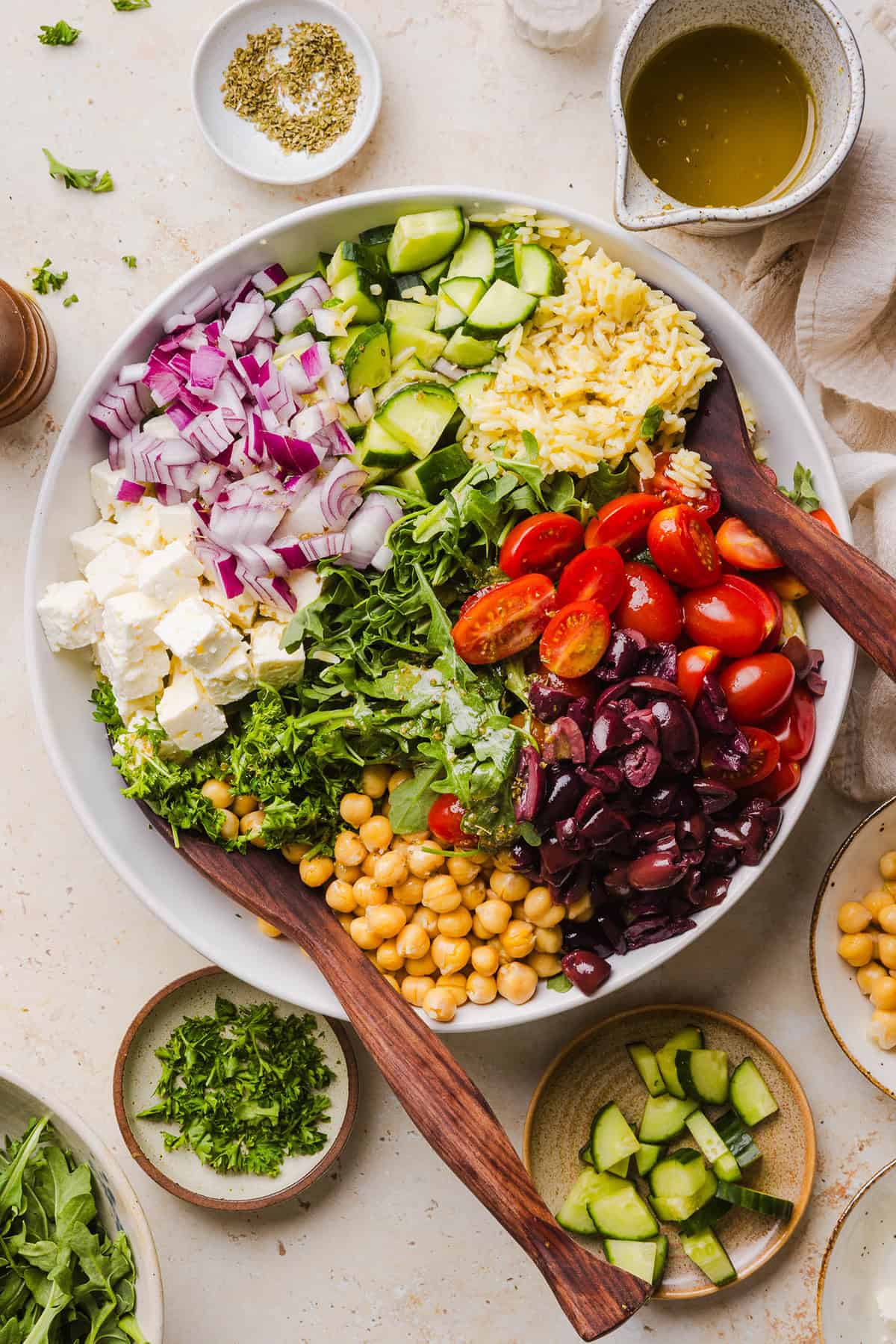 This Easy Greek Orzo Salad is packed with fresh veggies, chickpeas, feta, and the most delicious homemade lemon herb dressing. Perfect for meal prep, picnics, and summer cookouts!