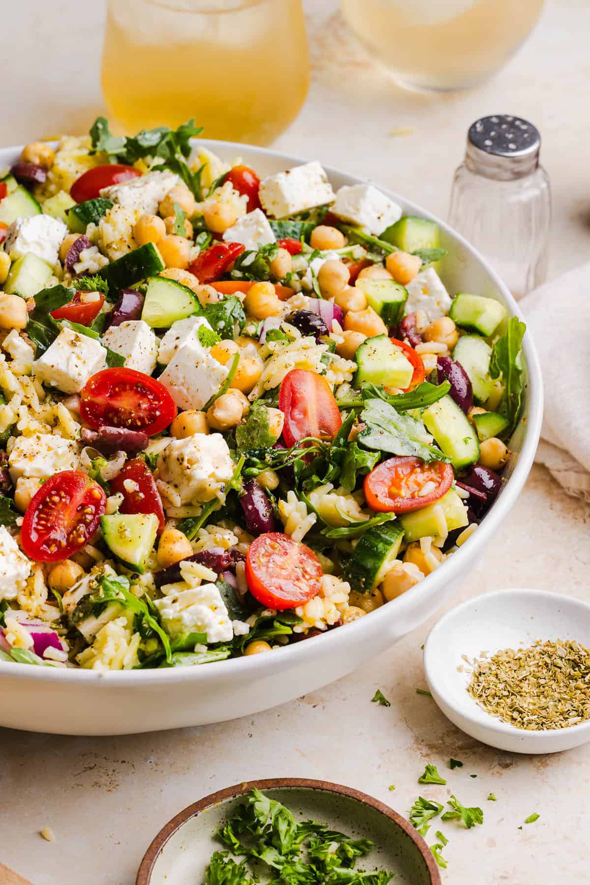 This Easy Greek Orzo Salad is packed with fresh veggies, chickpeas, feta, and the most delicious homemade lemon herb dressing. Perfect for meal prep, picnics, and summer cookouts!