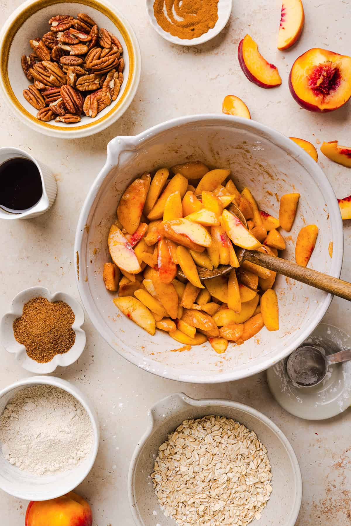 This Healthy Peach Crisp recipe is made with juicy fresh peaches and a wholesome oat pecan crumble naturally sweetened with maple syrup. An easy summer dessert that is warm, cozy, and perfect with vanilla ice cream!