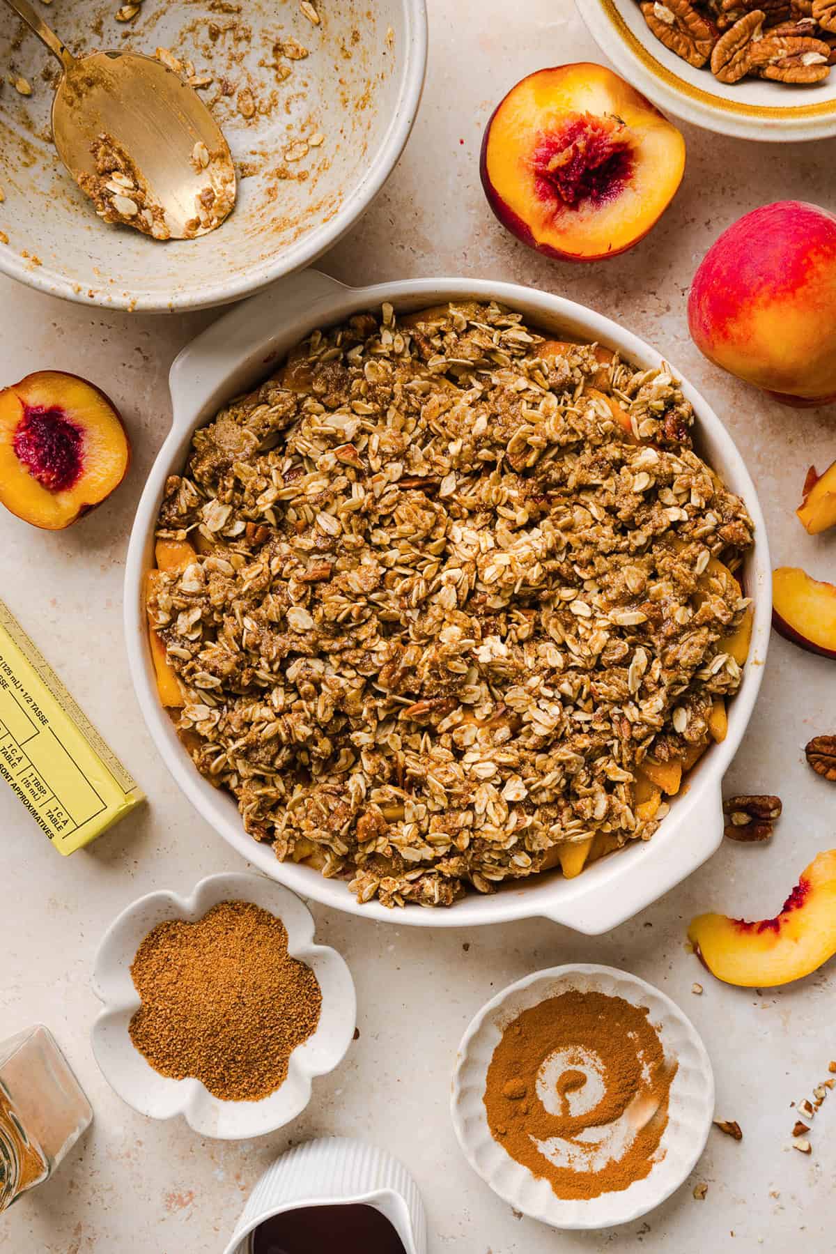 This Healthy Peach Crisp recipe is made with juicy fresh peaches and a wholesome oat pecan crumble naturally sweetened with maple syrup. An easy summer dessert that is warm, cozy, and perfect with vanilla ice cream!