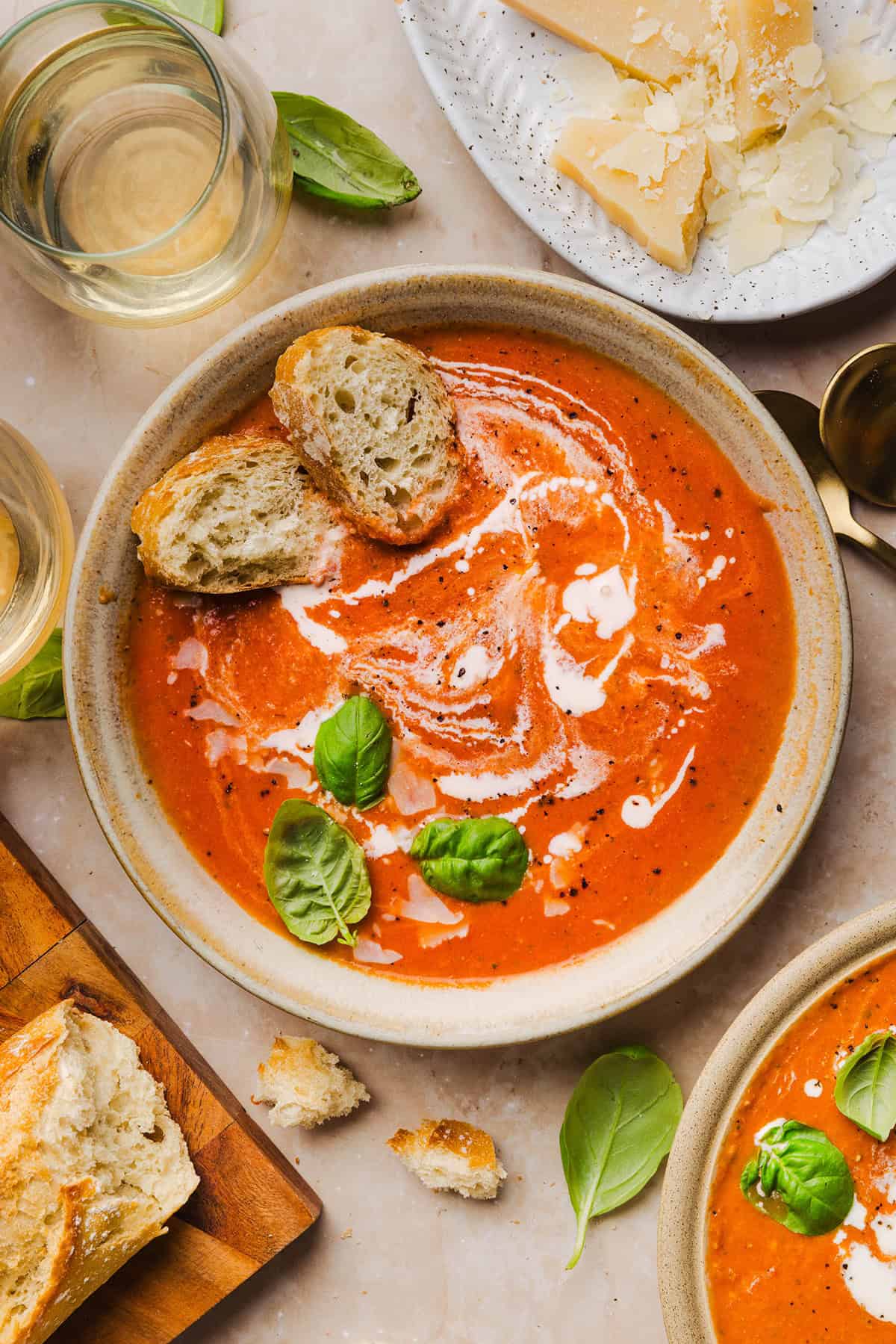 Creamy tomato basil soup served in a bowl with crusty bread
