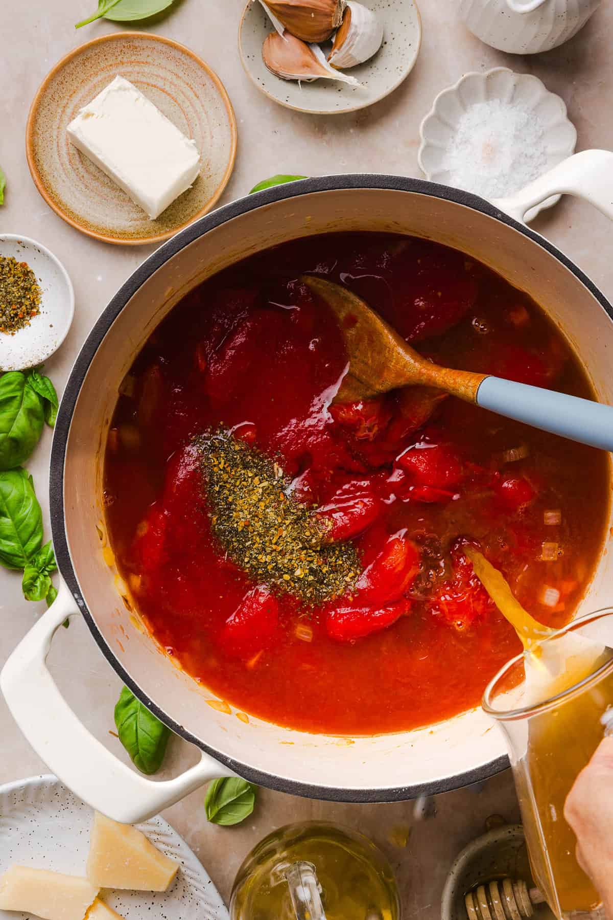 Tomato basil soup ingredients going in the pot