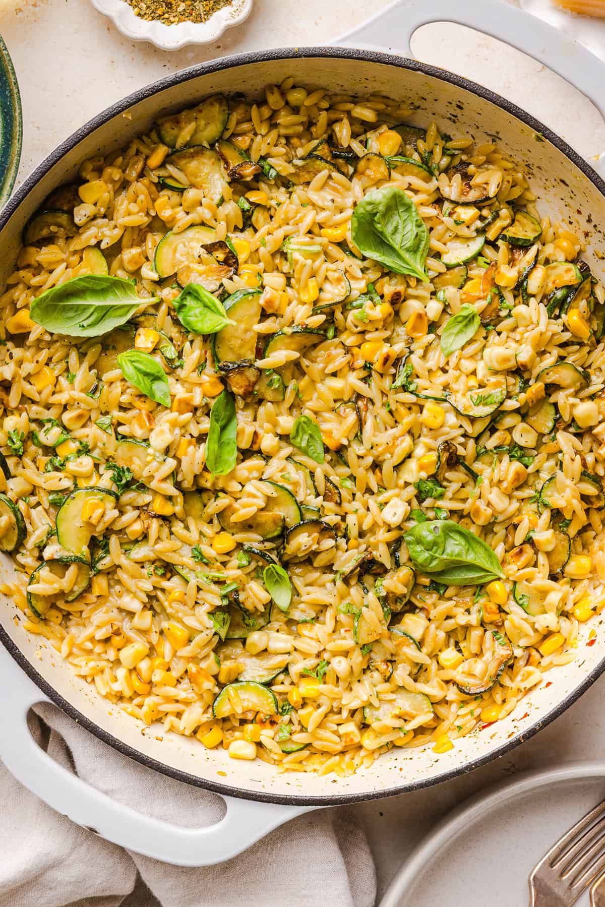 This creamy One Pan Lemon Garlic Orzo with Zucchini and Corn is fresh, flavorful and made in one skillet for an easy summer side dish or weeknight meal. Packed with fresh veggies, tender orzo, Parmesan, herbs and bright lemon flavor!