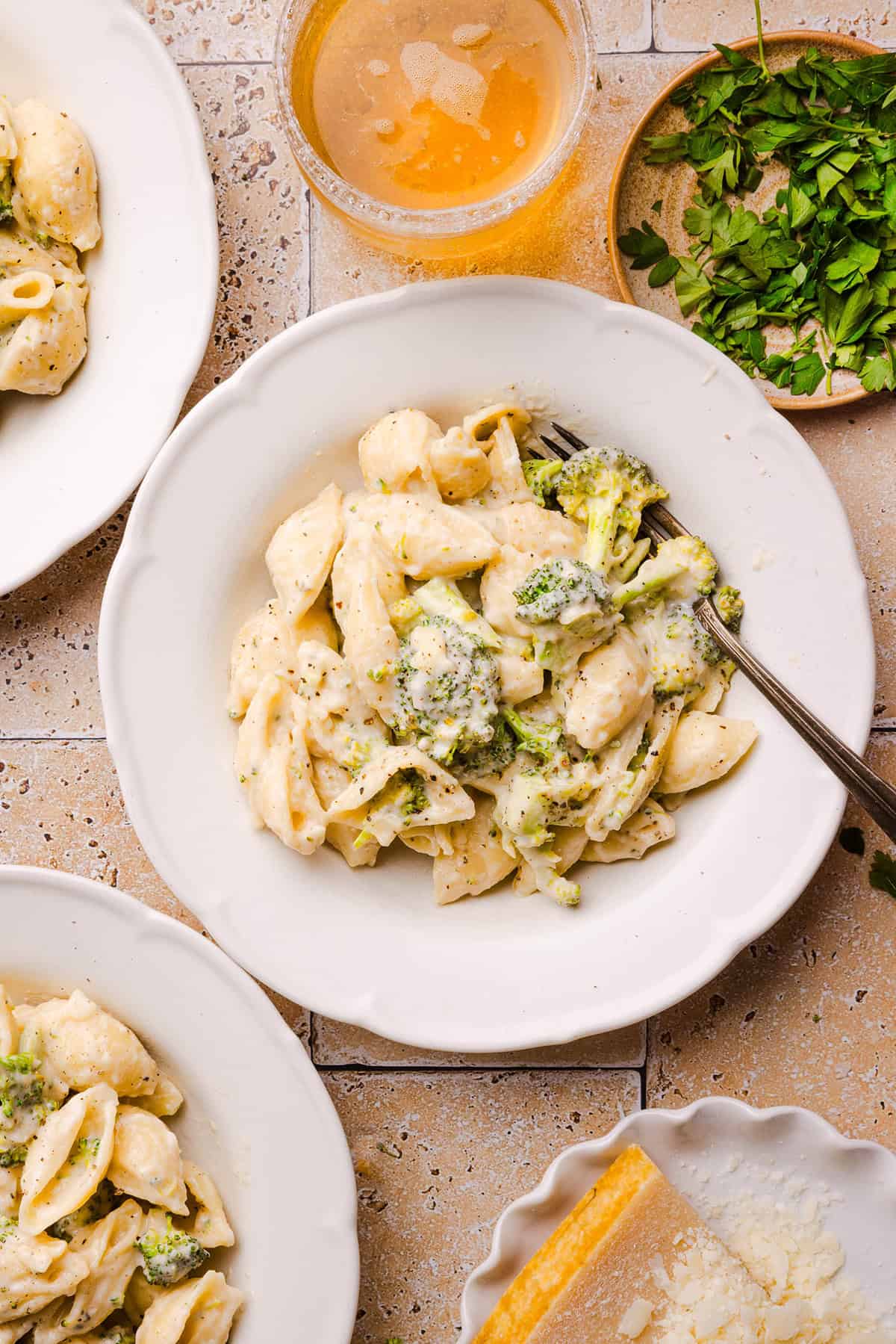 Creamy broccoli cheddar pasta with tender pasta shells and chopped broccoli ready to serve.